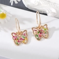 Detail of golden butterfly earrings with real dried flowers embedded in clear resin hooks - Butterfly
