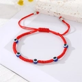 Detail of red woven Evil Eye bracelet with blue beads and adjustable sliding knot closure - Five Beads Style / Red