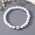 Elegante bracciale di perle d'acqua dolce con ciondolo occhio greco viola e perline oro - Viola