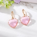 Roze hart kristallen oorringen met goudkleurige afwerking en zirkoon op witte display - Pave Haak / Roze