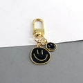 Llavero de doble cara sonriente en metal dorado con colgantes negros esmaltados de moda - Negro Doble Sonrisa