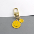 Llavero elegante con doble cara sonriente de esmalte amarillo y clip de metal dorado - Amarillo Doble Sonrisa