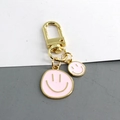 Llavero con cara sonriente rosa y cierre de metal dorado para bolsos y llaves - Rosa Doble Sonrisa