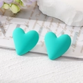 Detail of tiffany blue heart earrings with a matte finish on a decorative background - Lake Green