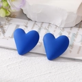 Detail of Klein Blue matte heart earrings on a stylish white textured background - Dark Blue
