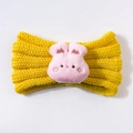 Close-up of a yellow knitted baby headband with a cute pink plush bunny decoration - Yellow