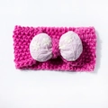 Detail of baby knitted headband featuring rose pink yarn and purple bow with white flower embroidery - Rose Red
