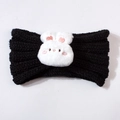 Close-up of black knitted baby headband featuring a cute white plush bunny accessory - Black