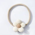 Close-up detail of soft corduroy flower hairband for infants with high elastic nylon strap - Beige