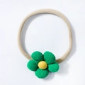 Detail of baby elastic headband with handcrafted green corduroy flower and yellow center - Green