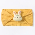 Detail of yellow knit baby headband with cute plush rabbit ornament and cable texture - Yellow