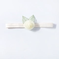 Detailopname van de ivoren rozen hoofdband met fijn geborduurde groene bladeren voor baby's - Beige