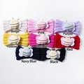 Flat lay detail showing 8 colors of knitted baby headbands with 3D bee decorations - 8 Colors Mixed
