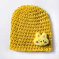 Detail of yellow knit baby hat with a cute 3D bunny ornament and soft texture - Yellow