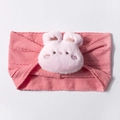 Detailed close-up of pink ribbed knit baby headband with cute plush rabbit decoration - Dust Rose