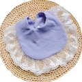 Detailed macro view of purple waffle cotton baby bib with delicate white lace edges - Purple
