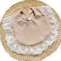 Detailed view of beige waffle fabric baby bib with white lace trim and button snap - Light Coffee