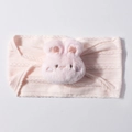 Detail of pink knitted baby headband featuring a cute plush bunny with cable knit texture - Light Pink