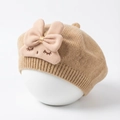 Detail of baby knitted beret with pink 3D bow and delicate embroidered expression - Coffee