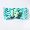 Detail of mint green knitted baby headband with decorative floral fabric accent - Mint Green