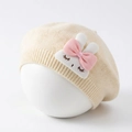 Detail view of cream knit baby beret with a 3D bunny plush and pink silk bow - Beige