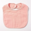 Detail view of pink multi-layer cotton gauze baby bib featuring a soft snap closure - Pink