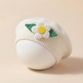 Detailed close-up of a white knitted baby beret featuring a soft plush 3D flower accent - Beige