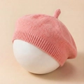 Detail of pink knitted baby beret showing the soft texture and ribbed knit edge detail - Watermelon red