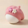 Detailed view of pink knitted baby beret with handmade floral accents and top pompom - Dusky Pink