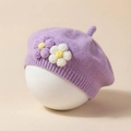 Close-up of a purple knitted baby beret featuring 3D floral details and soft texture - Purple