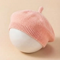 Detailed knit texture of pink baby beret with ribbed rim and cute pointed top - Pink