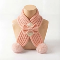 Detail of pink knitted baby scarf with center bow and soft plush pom poms at the ends - Pale Green