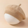 Detail of soft knitted baby beret in beige with ribbed edge and top stem ornament - Coffee
