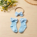 Detail of light blue cotton ribbed baby headband and socks with delicate bow accents - Blue