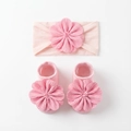 Detail of pink baby headband and socks set featuring large 3D floral petals and pearls - Light Pink