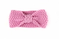 Close-up of pink knit baby headband showing thick texture and central twist knot detail - Pink