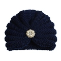 Detailed texture of navy blue knit beanie with a central pearl and rhinestone floral brooch - Adjustable / Navy Blue