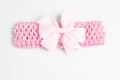 Pink wide crochet headband for babies featuring a large decorative ribbed bow - Light Pink