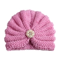 Detail of pink knitted infant turban hat with a centered pearl and rhinestone flower - Adjustable / Pink