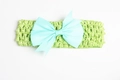 Elastic crochet baby headband featuring a light green textured bow for infant girls - Cyan
