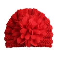 Detailed macro view of heavy red knit baby hat featuring a large layered fabric flower decoration - One Size / Red