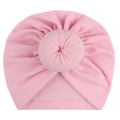 Detail of soft pink baby turban hat featuring a signature circular donut top knot - Pink