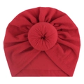 Close-up of bright red baby turban hat with a decorative donut knot detail in center - Red
