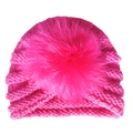 Detail of rose red baby turban hat featuring a fluffy faux fur pom-pom and knit texture - One Size / Rose Red