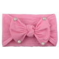 Detail of pink nylon baby headband with ribbed texture, large bow and white pearls - Pink