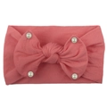Detail of pink nylon headband with a large bow and white faux pearls for baby girls - Watermelon red