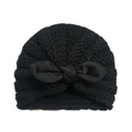 Close-up of black knitted baby turban beanie with large bow decoration on white background - Black