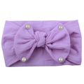 Detail of soft nylon lavender baby headband featuring a large bow and pearl accents - Purple