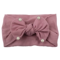 Close-up of baby nylon headband with dusty rose bow and delicate white pearl accents - Taro Purple