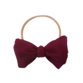 Detailed shot of dark wine red waffle texture bow on a beige nylon baby headband - One Size / Burgundy